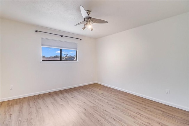 unfurnished room with a textured ceiling, ceiling fan, and light hardwood / wood-style flooring