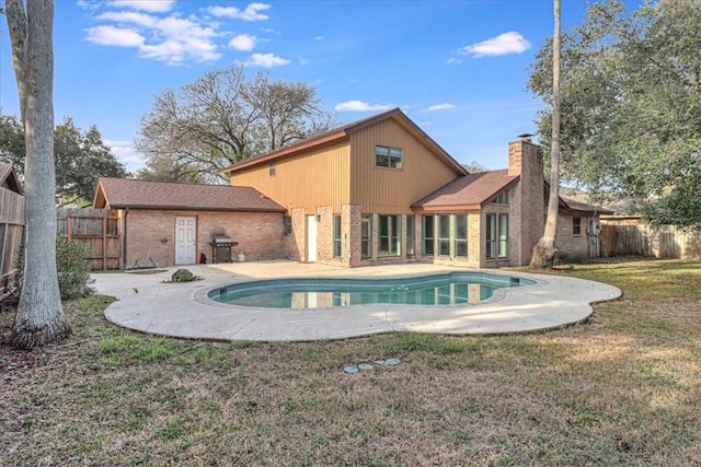 view of pool with a grill, a yard, and a patio