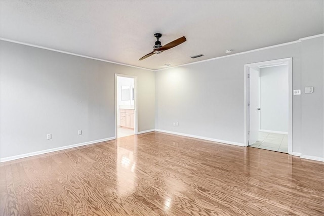 empty room with ceiling fan, crown molding, and light hardwood / wood-style flooring