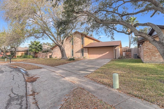 view of front of house featuring a garage, a front yard, and central air condition unit