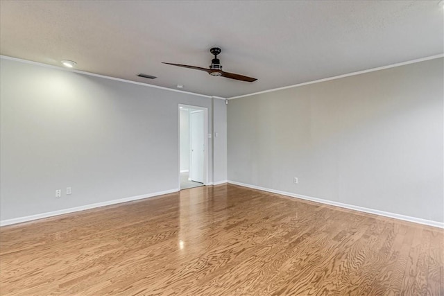 empty room featuring ceiling fan, crown molding, and light hardwood / wood-style flooring