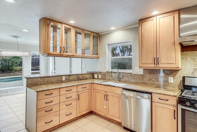 kitchen featuring crown molding, appliances with stainless steel finishes, light brown cabinetry, and sink