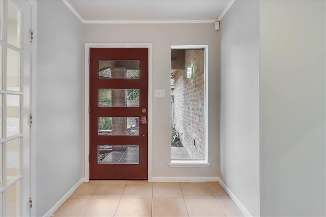 foyer with light tile patterned floors and crown molding