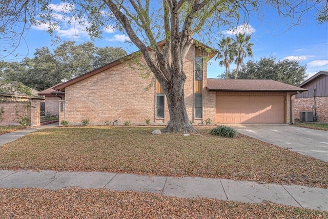 view of front of home featuring central AC, a front lawn, and a garage