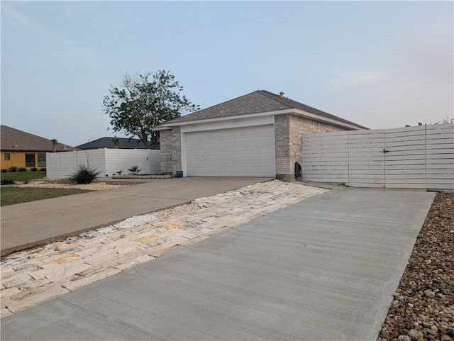 13829 Suntan Ave, Corpus Christi, TX 78418 - view of front of home with concrete driveway, a garage, and brick siding