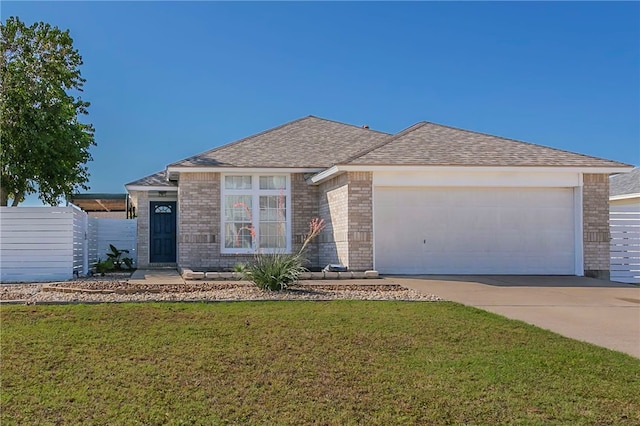 ranch-style home featuring a garage and a front lawn