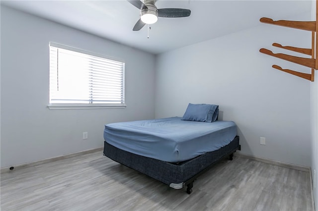 bedroom with ceiling fan and light wood-type flooring