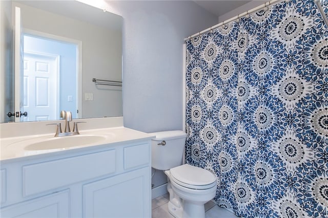 bathroom featuring tile patterned flooring, vanity, curtained shower, and toilet