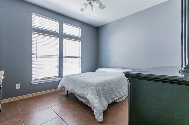 bedroom featuring tile patterned floors and ceiling fan