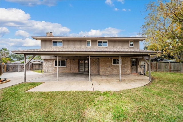 5049 Moultrie Dr, Corpus Christi, TX 78413 - rear view of house with a patio, brick siding, and a chimney