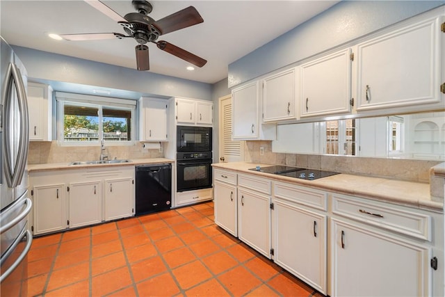 5049 Moultrie Dr, Corpus Christi, TX 78413 - kitchen with black appliances, a sink, light countertops, backsplash, and white cabinetry
