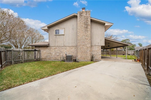 5049 Moultrie Dr, Corpus Christi, TX 78413 - view of property exterior featuring a chimney, central AC, concrete driveway, brick siding, and an attached carport