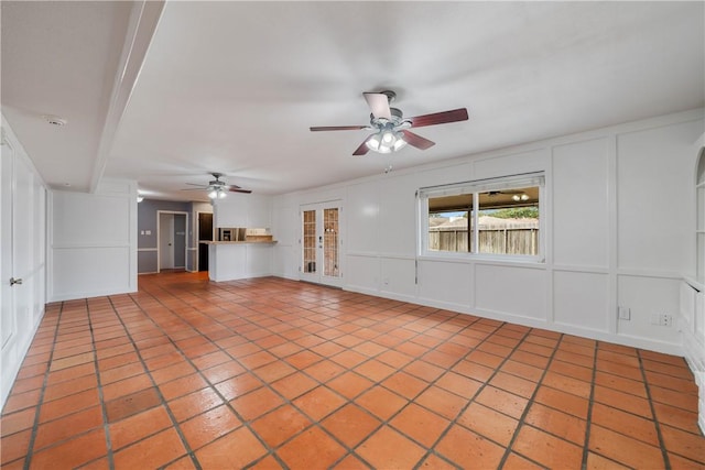 unfurnished living room with ceiling fan