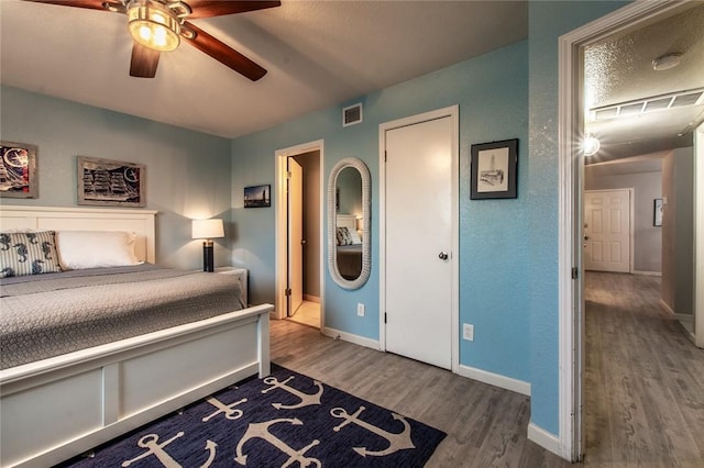 bedroom featuring a textured ceiling, ceiling fan, and hardwood / wood-style flooring