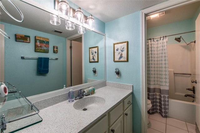 full bathroom featuring toilet, a textured ceiling, tile patterned floors, shower / bath combo, and vanity