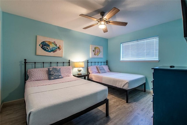 bedroom featuring ceiling fan and hardwood / wood-style flooring