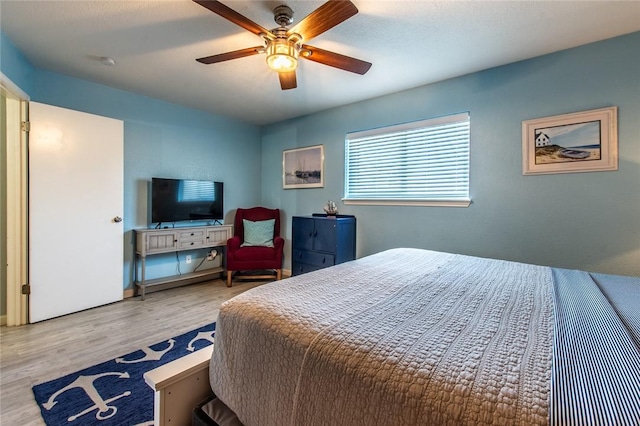 bedroom with ceiling fan and light hardwood / wood-style floors