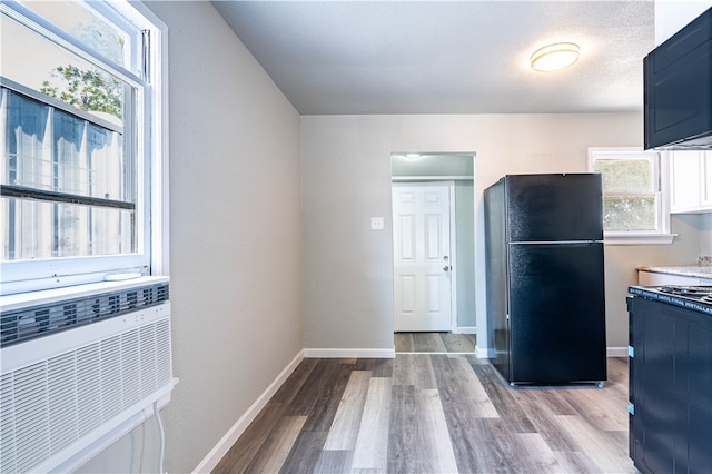 kitchen featuring black fridge and light hardwood / wood-style flooring