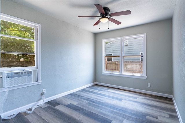 unfurnished room with hardwood / wood-style floors, ceiling fan, and cooling unit