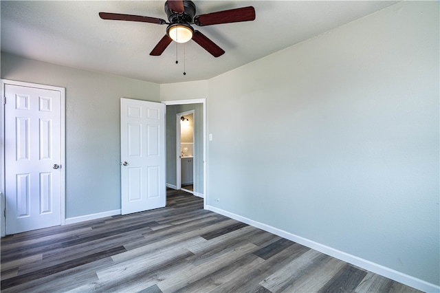 unfurnished bedroom with ceiling fan and dark hardwood / wood-style floors