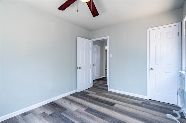 unfurnished bedroom with ceiling fan and dark hardwood / wood-style floors