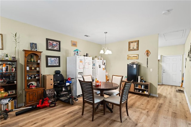 105 E Elm St, Taft, TX 78390 - dining room featuring light wood-style flooring and a chandelier