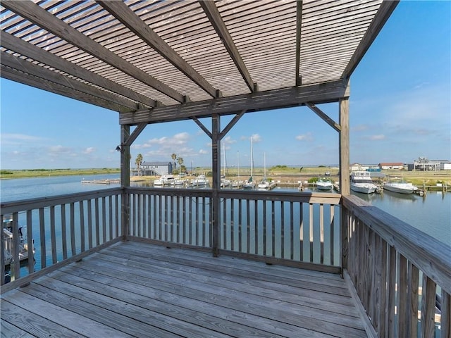 wooden terrace with a water view and a pergola