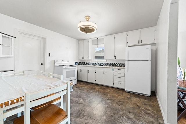 kitchen with white appliances, baseboards, light countertops, white cabinetry, and a sink