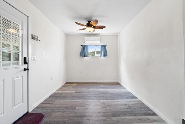 unfurnished room with ceiling fan, baseboards, and wood finished floors