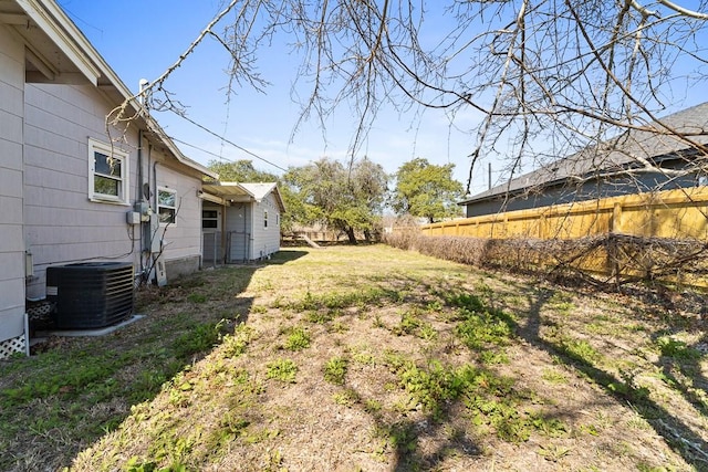 view of yard with fence and cooling unit