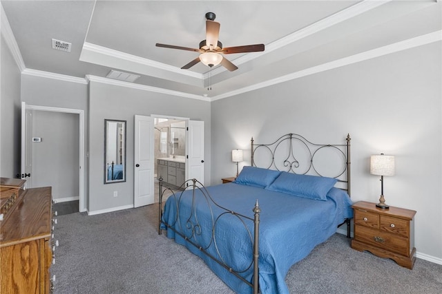 carpeted bedroom with crown molding, a raised ceiling, baseboards, and visible vents