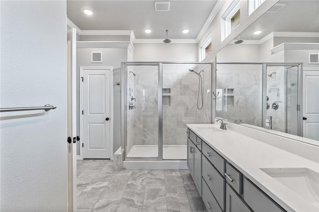 bathroom with a sink, ornamental molding, a shower stall, and visible vents