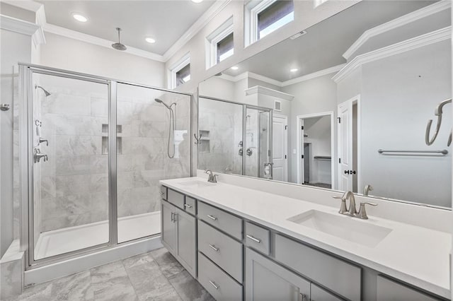 full bath featuring a sink, ornamental molding, a stall shower, and double vanity