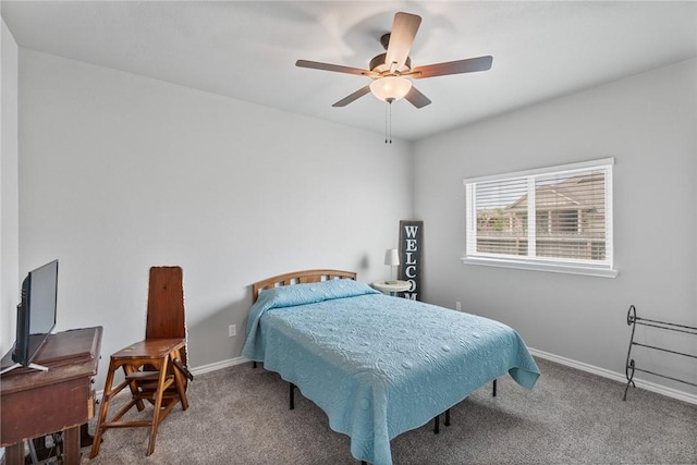 carpeted bedroom featuring baseboards and ceiling fan