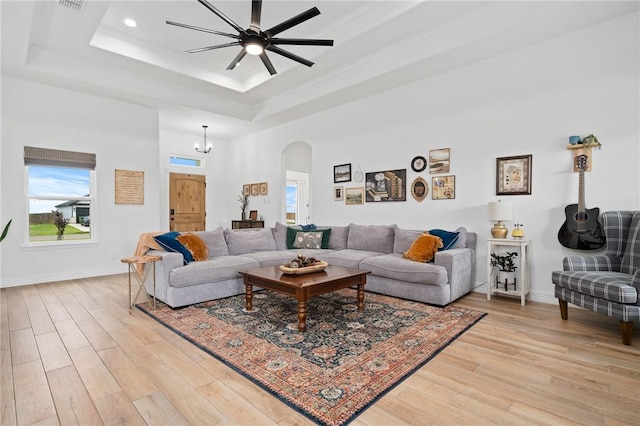133 Longhorn Dr, Odem, TX 78370 - living room with a tray ceiling, arched walkways, light wood-type flooring, healthy amount of natural light, and recessed lighting