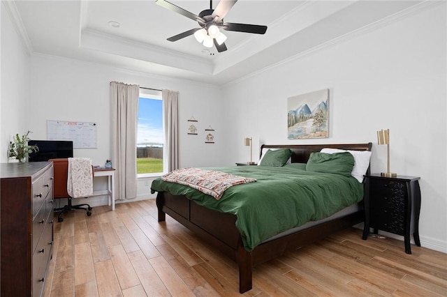 133 Longhorn Dr, Odem, TX 78370 - bedroom featuring a raised ceiling, light wood-style flooring, a desk, ornamental molding, and a ceiling fan