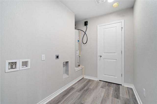 laundry area with electric dryer hookup, washer hookup, wood finished floors, baseboards, and laundry area