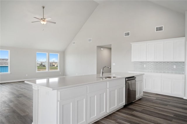 kitchen with stainless steel dishwasher, light countertops, open floor plan, and visible vents