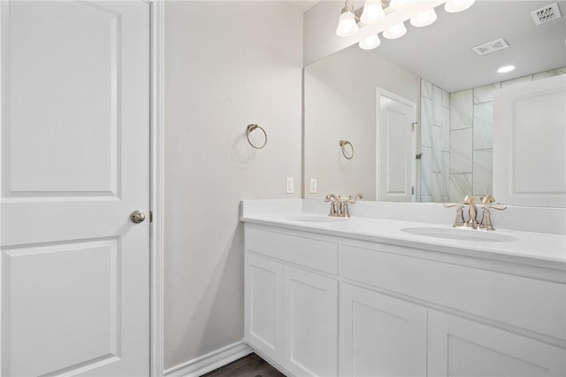 bathroom featuring double vanity, visible vents, and a sink