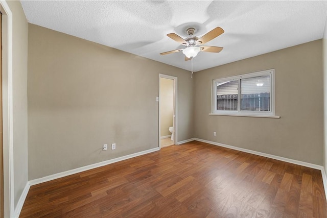 spare room featuring ceiling fan, hardwood / wood-style floors, and a textured ceiling