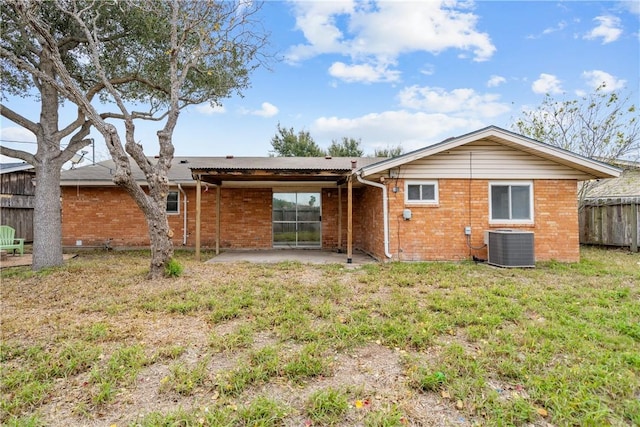 back of property featuring cooling unit, a yard, and a patio