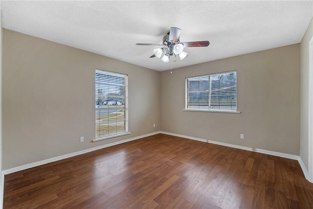 unfurnished room with ceiling fan, a textured ceiling, and dark hardwood / wood-style floors