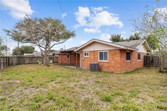 back of property with cooling unit and a yard