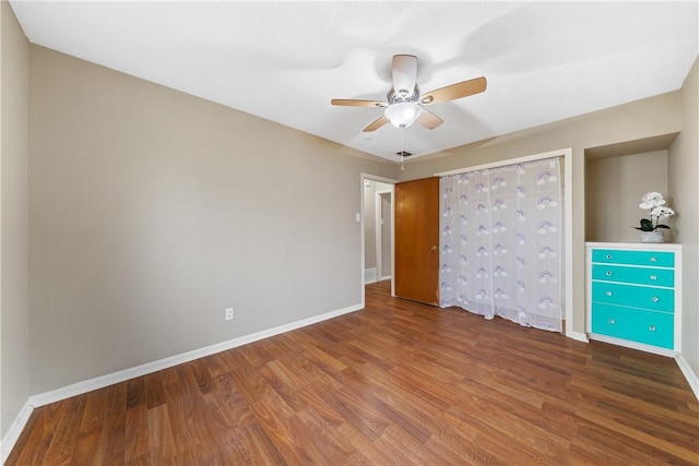 unfurnished bedroom with ceiling fan and wood-type flooring