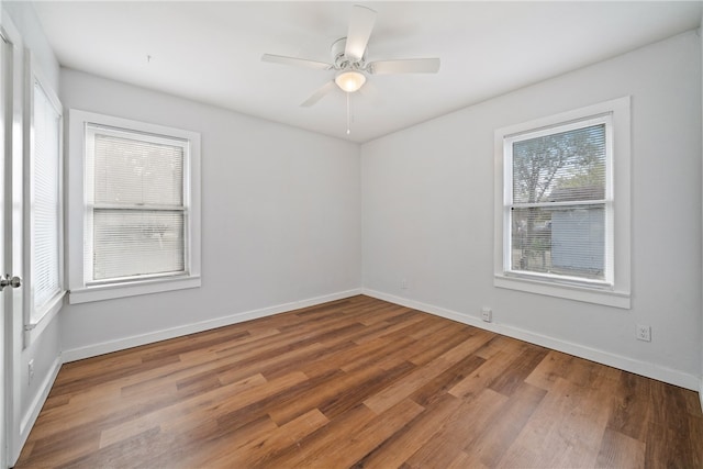 spare room with hardwood / wood-style flooring and ceiling fan