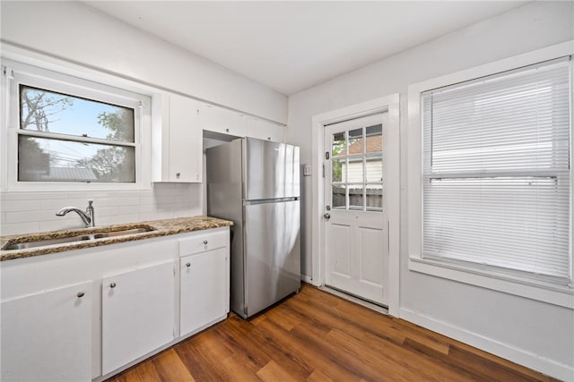 kitchen featuring white cabinetry, dark hardwood / wood-style flooring, sink, and stainless steel refrigerator