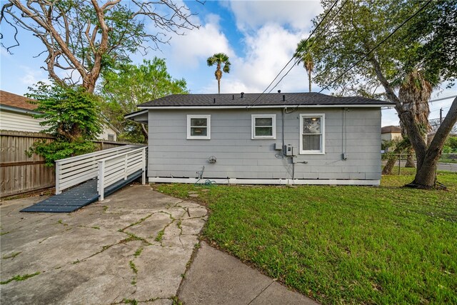 back of property featuring a patio area and a lawn