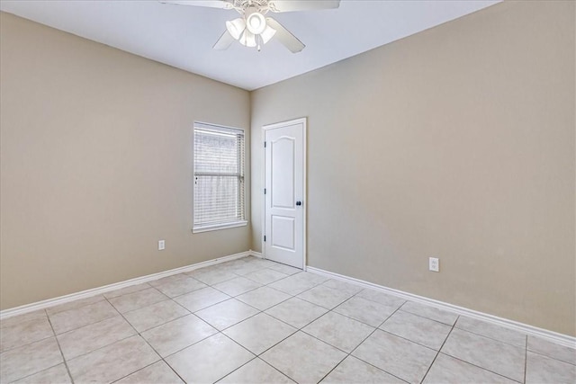 tiled spare room featuring ceiling fan