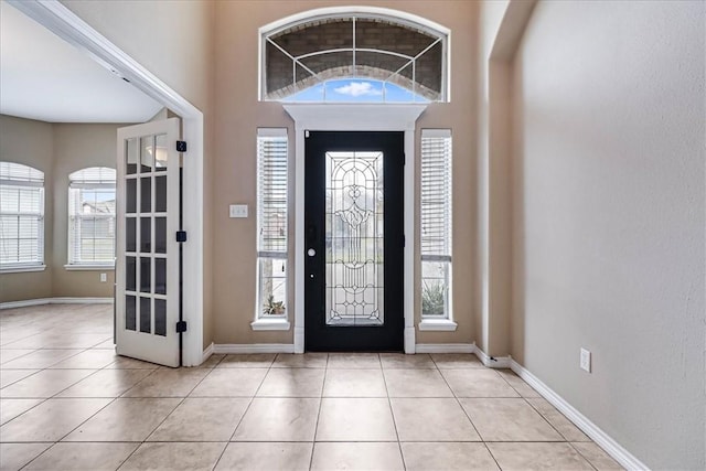 tiled foyer entrance featuring a wealth of natural light