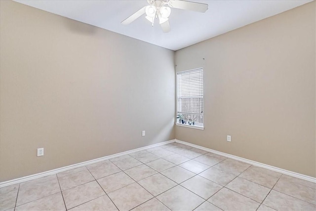 empty room with ceiling fan and light tile patterned flooring